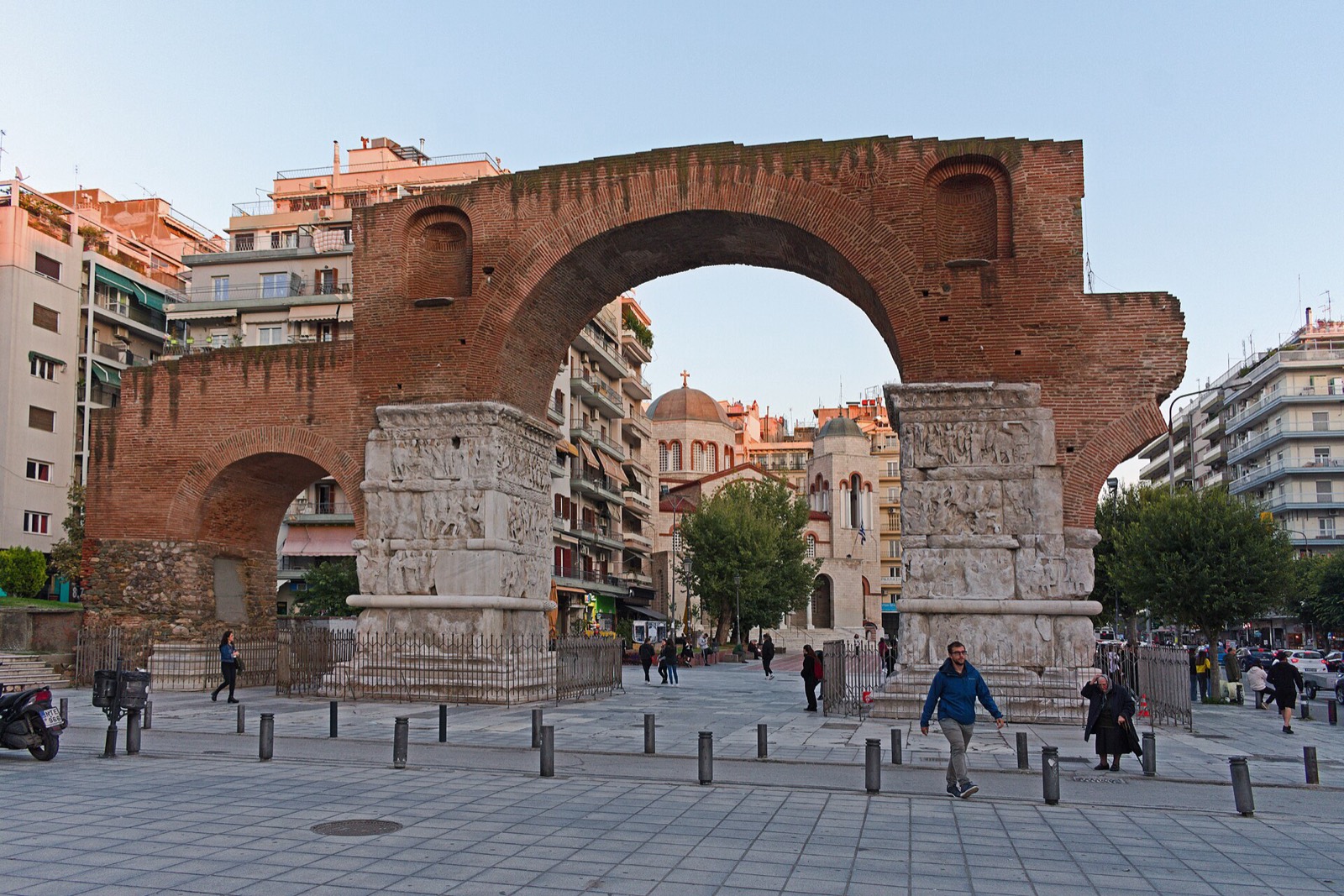 The Arch of Galerius with its carved Roman reliefs, people walking beneath