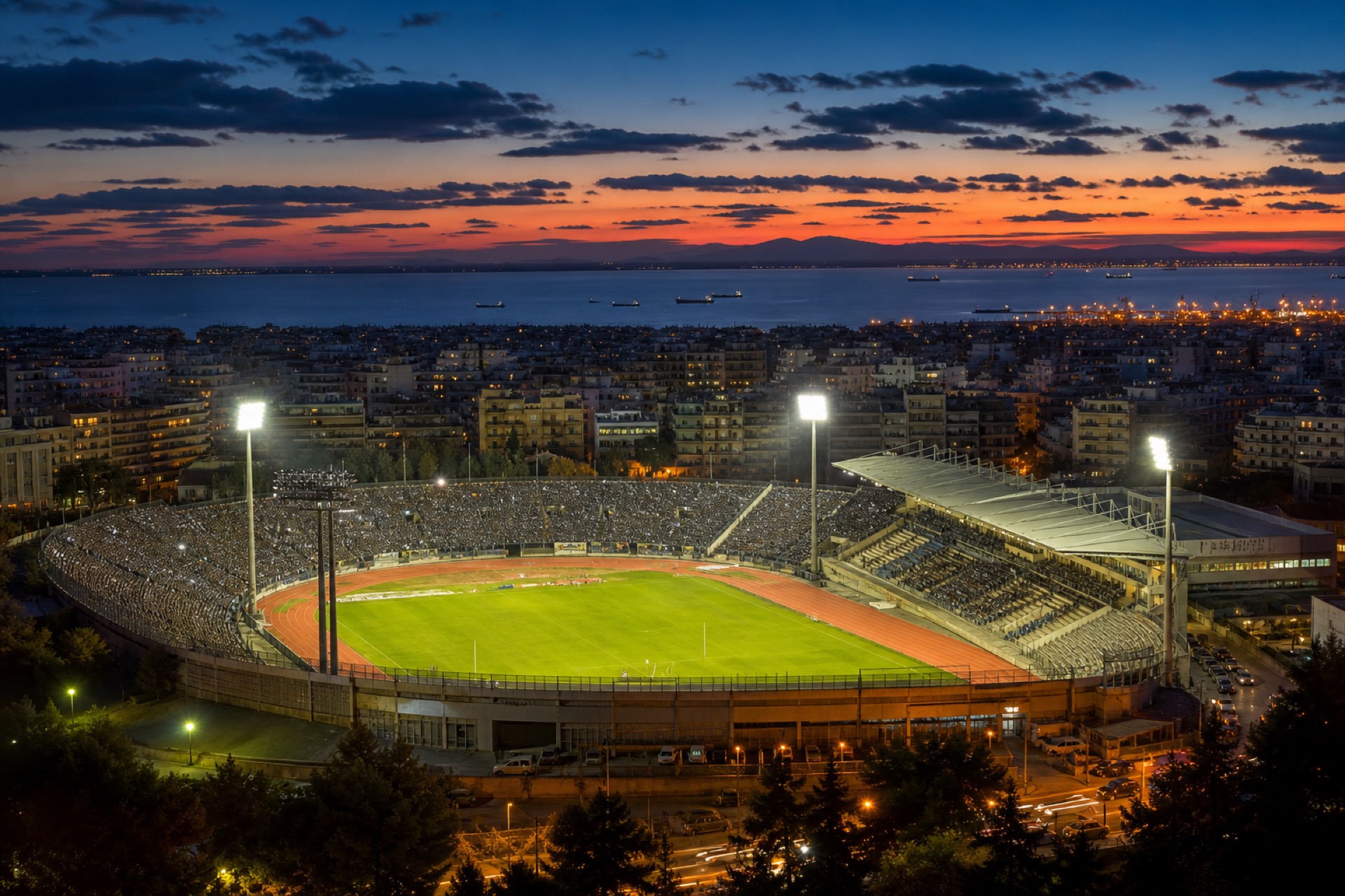 Floodlit football stadium atmosphere — Thessaloniki match night